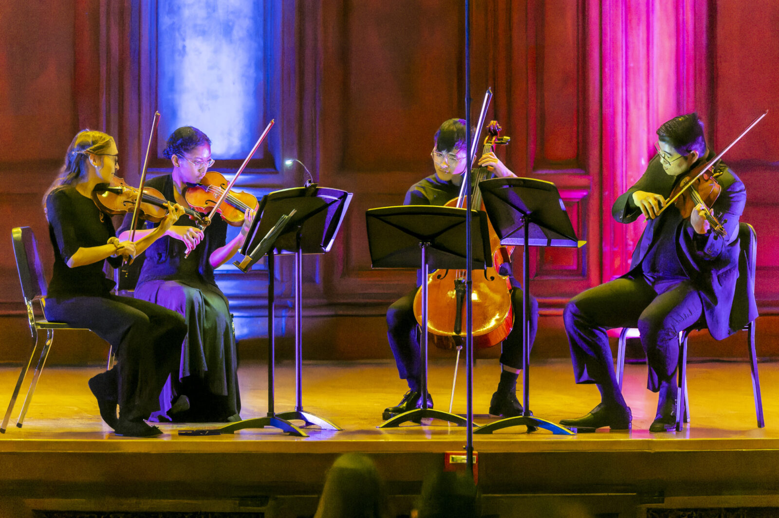 several string instrumentalists performing onstage