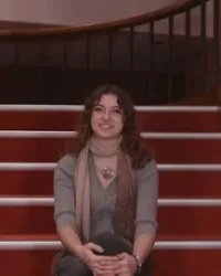 Person sitting on red staircase