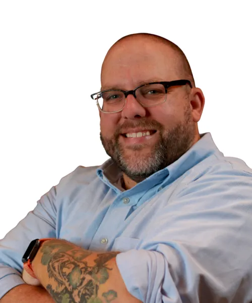 person with arms folded smiling