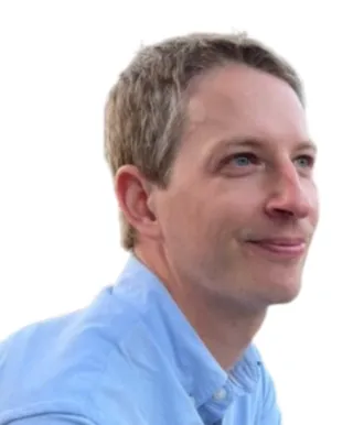 person wearing light blue collared shirt and smiling