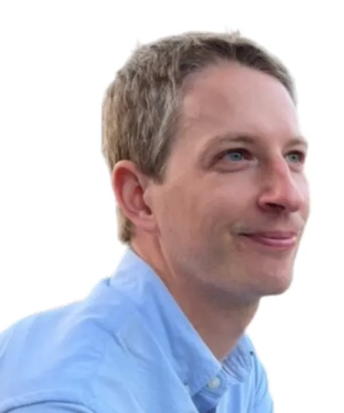 person wearing light blue collared shirt and smiling