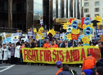 protesters with signs marching on city street