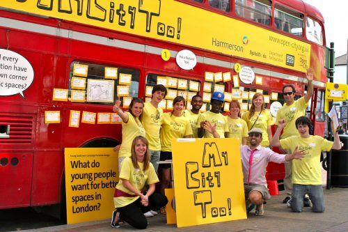Young people in front of a red double-decker bus