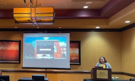 Emma Walters presenting in a conference room.