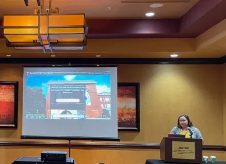 Emma Walters presenting in a conference room.