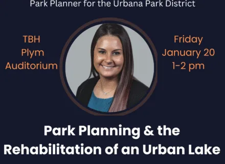 Photo of Ms. Dudek-Mizel in a blue blouse in front of a gray background