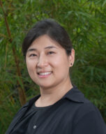 Photo of Colleen Chiu-Shee in front of green trees
