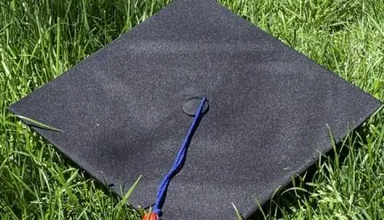 Photo of graduation cap on green grass