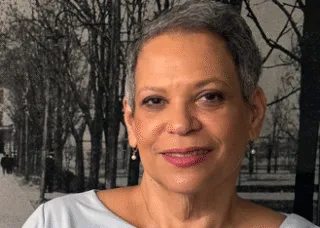Photo of Hazel Edwards in gray dress against a wall