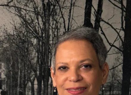 Photo of Hazel Edwards in gray dress against a wall