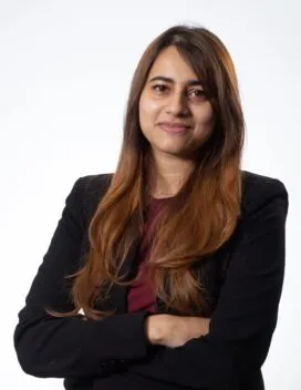 Phot of Sutapa Banerjee in black blazer in front of white background