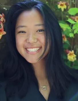Photo of Melanie Pane in front of vining yellow flowers