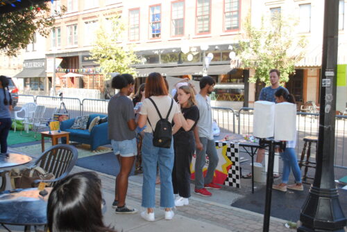 Photo of people enjoying Parking Day in 2018 in downtown Champaign
