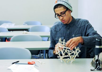 Student working on a stick model