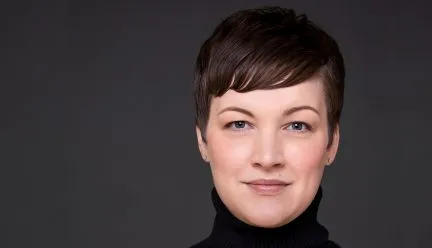 headshot of trina sandschafer against grey background 