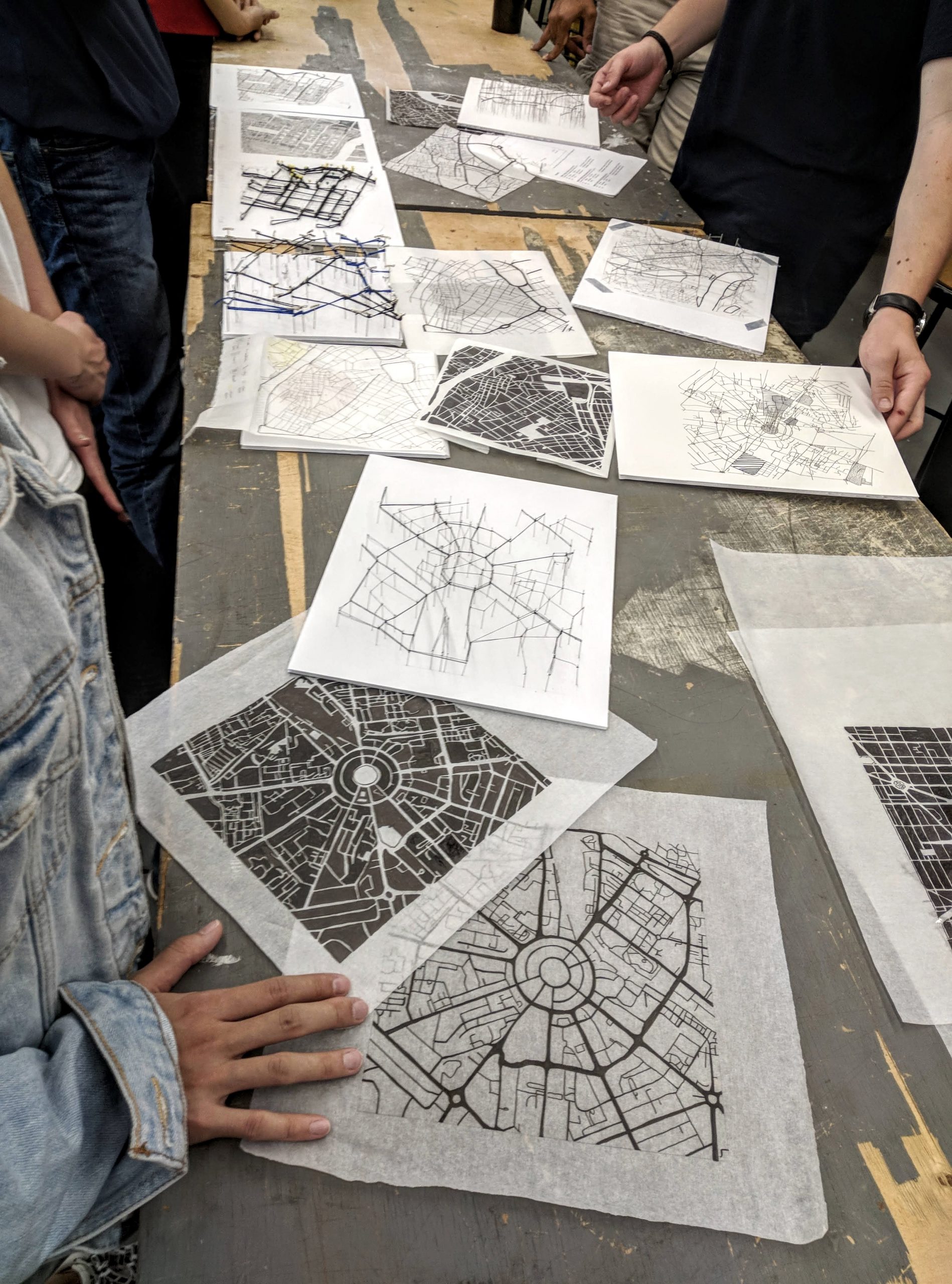 View of table covered in urban analysis drawings