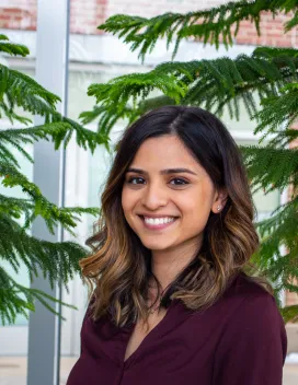 Headshot of Eshani Patel in front of pine trees 