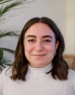 Headshot of Abby Peterson in front of a fern 