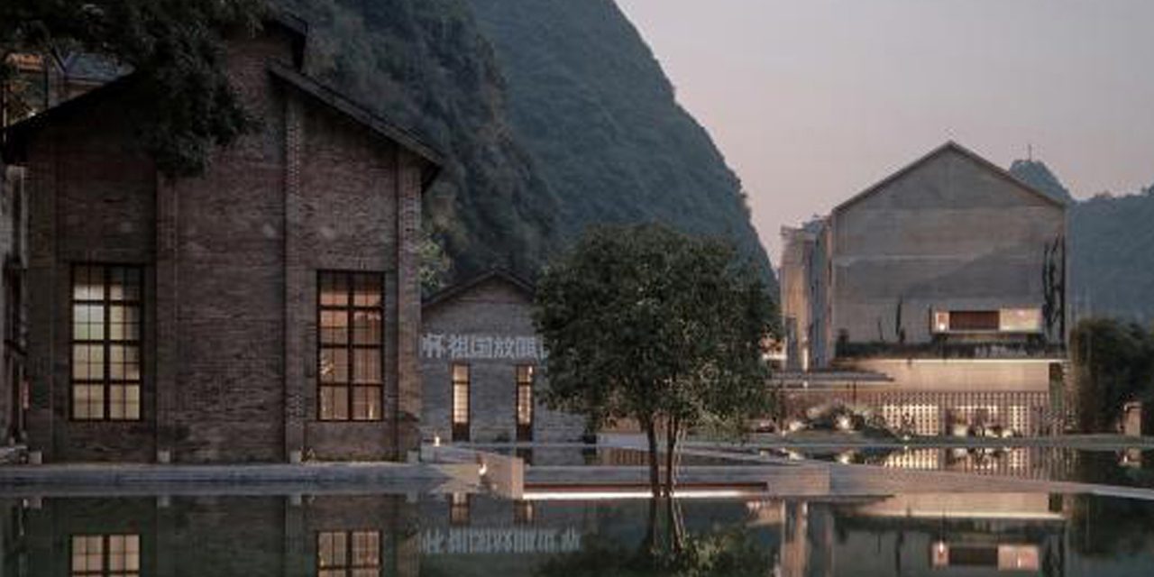 Looking at two gable roof buildings across a pond