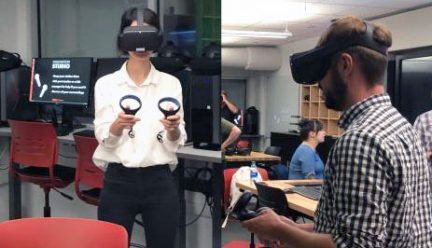 two students wearing virtual reality goggles