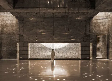 a person standing in front of a brilliantly lit wall with dancing lights