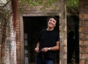 solano benitez in front of a masonry building 