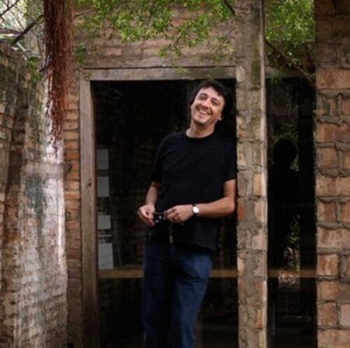 solano benitez in front of a masonry building 