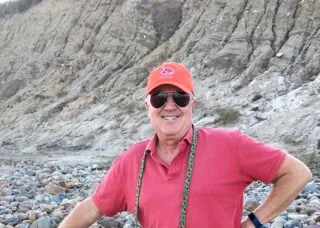 photo of doug gilpin standing on a rocky beach