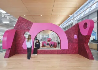 Pink architectural installation inside a campus building 