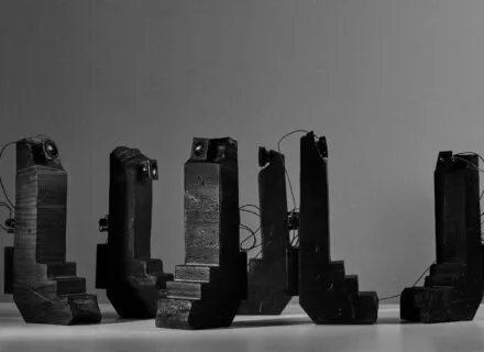 black sculptures in a grey gallery