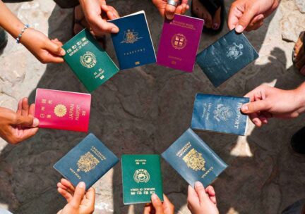 People holding passports in a circle