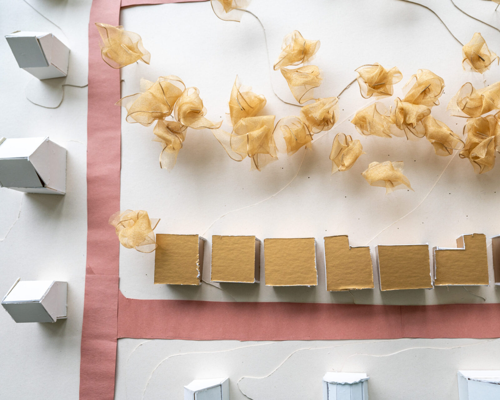 small scaled buildings with toilet tissue glued to nails, red construction paper as roads