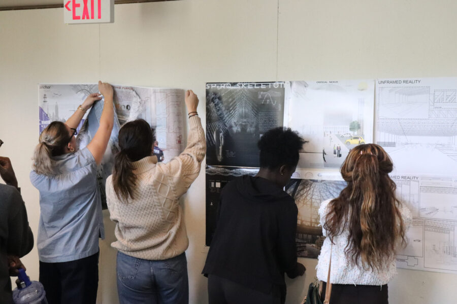 pic of students pinning up work in cafe