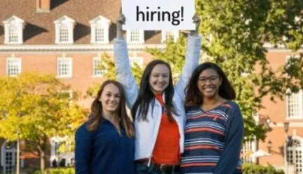 three students holding a sign that says "hiring"