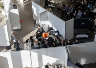 picture of the atrium with students during their fall 2024 midterm studio reviews