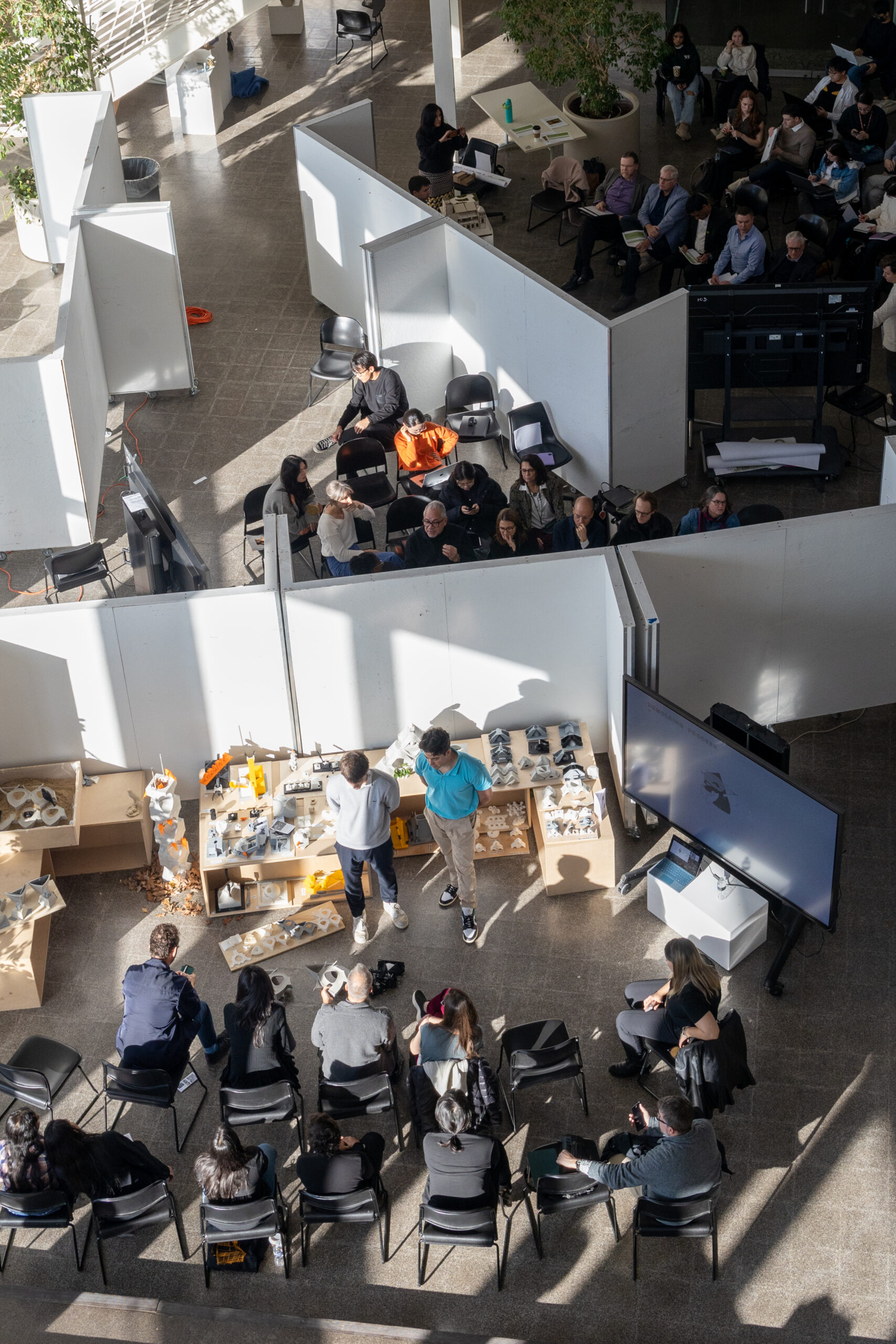 picture of the atrium with students during their fall 2024 midterm studio reviews