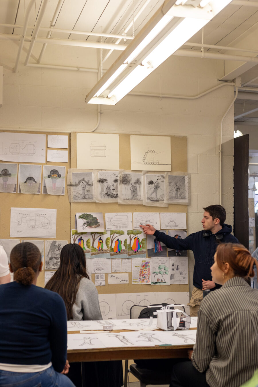 first year arch presentation. Ssudents watching, one student presenting