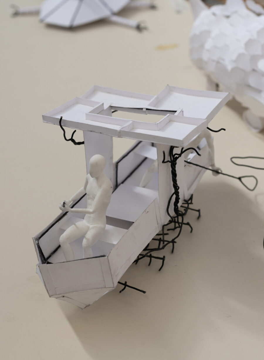 first year arch student model of a boat, white, rectangular, triangular front and square back with canopy in middle