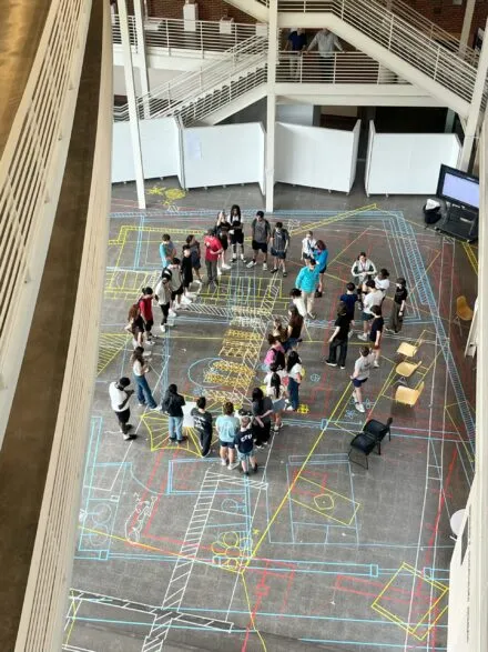 students standing in temple buell hall atrium