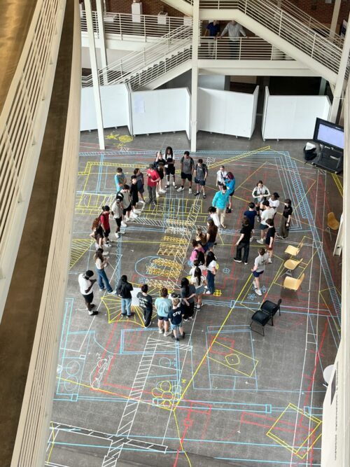 students standing in temple buell hall atrium