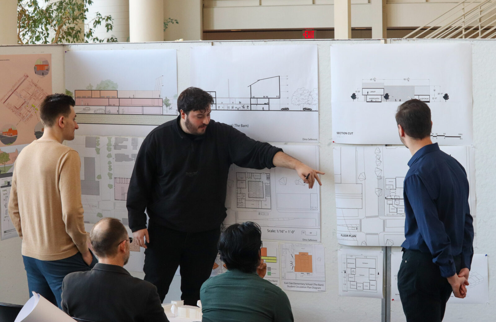 arch TA discussing student project as part of presentaiton