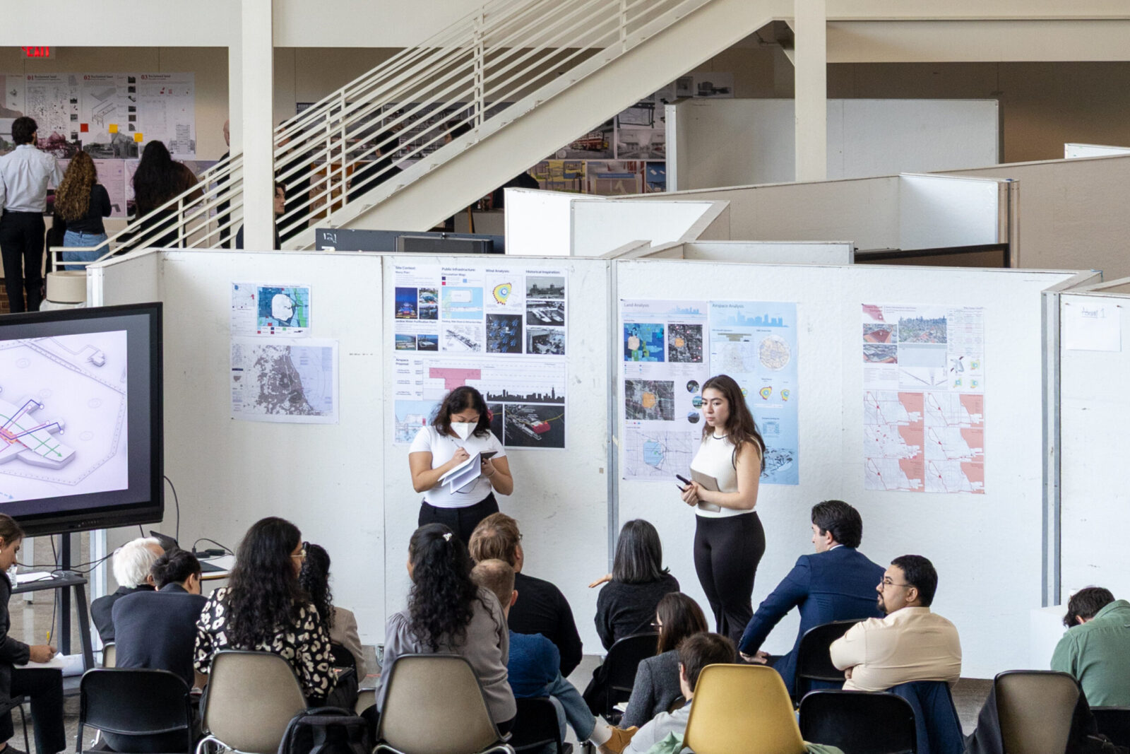 two people presenting architectural projects to an audience