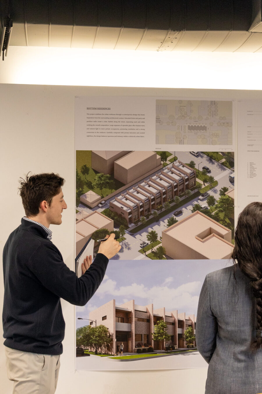 people reviewing pictures of building mock ups
