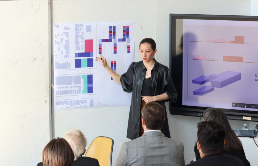 a student presenting from a poster