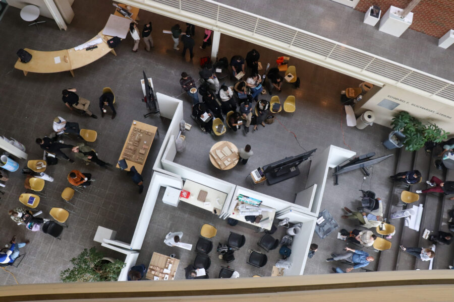 an overhead view of the atrium with people looking at projects