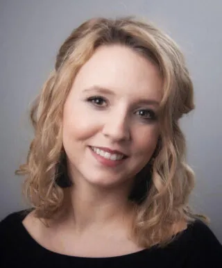 blonde white woman smiling into camera 