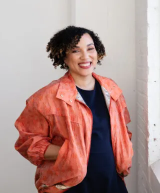 ai generated image of woman with black pigmentation and black hair smiling at camera