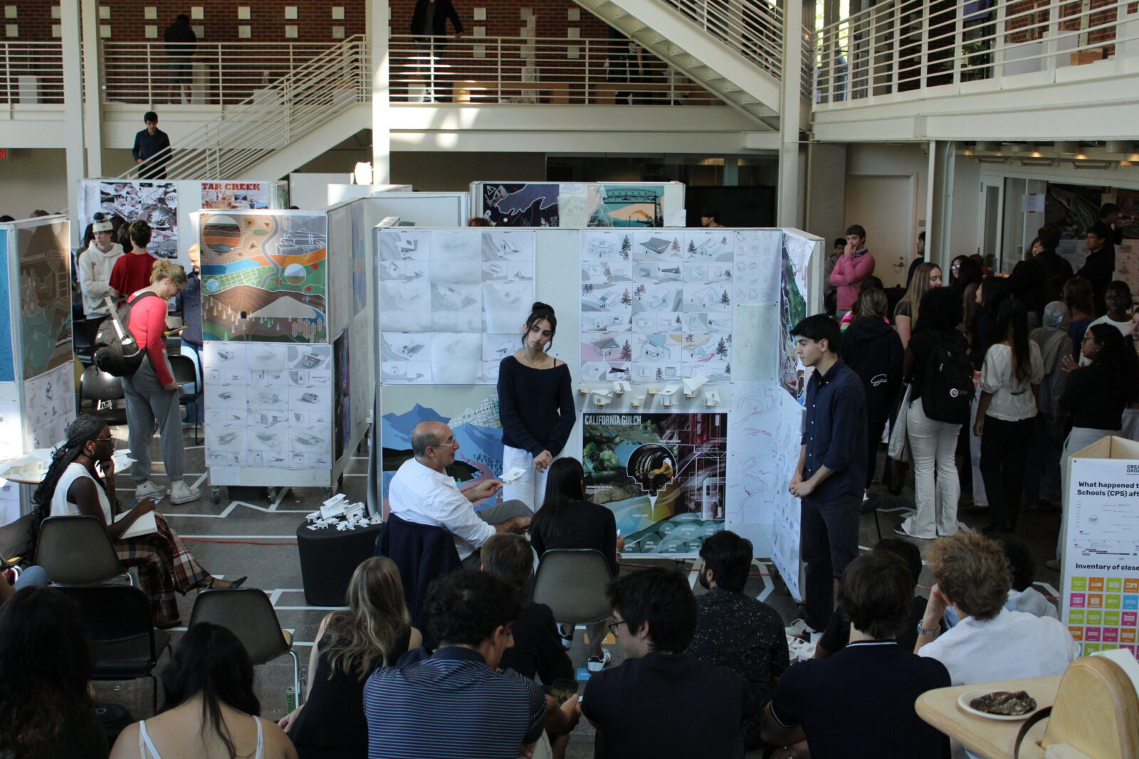students presenting architecture projects for an audience