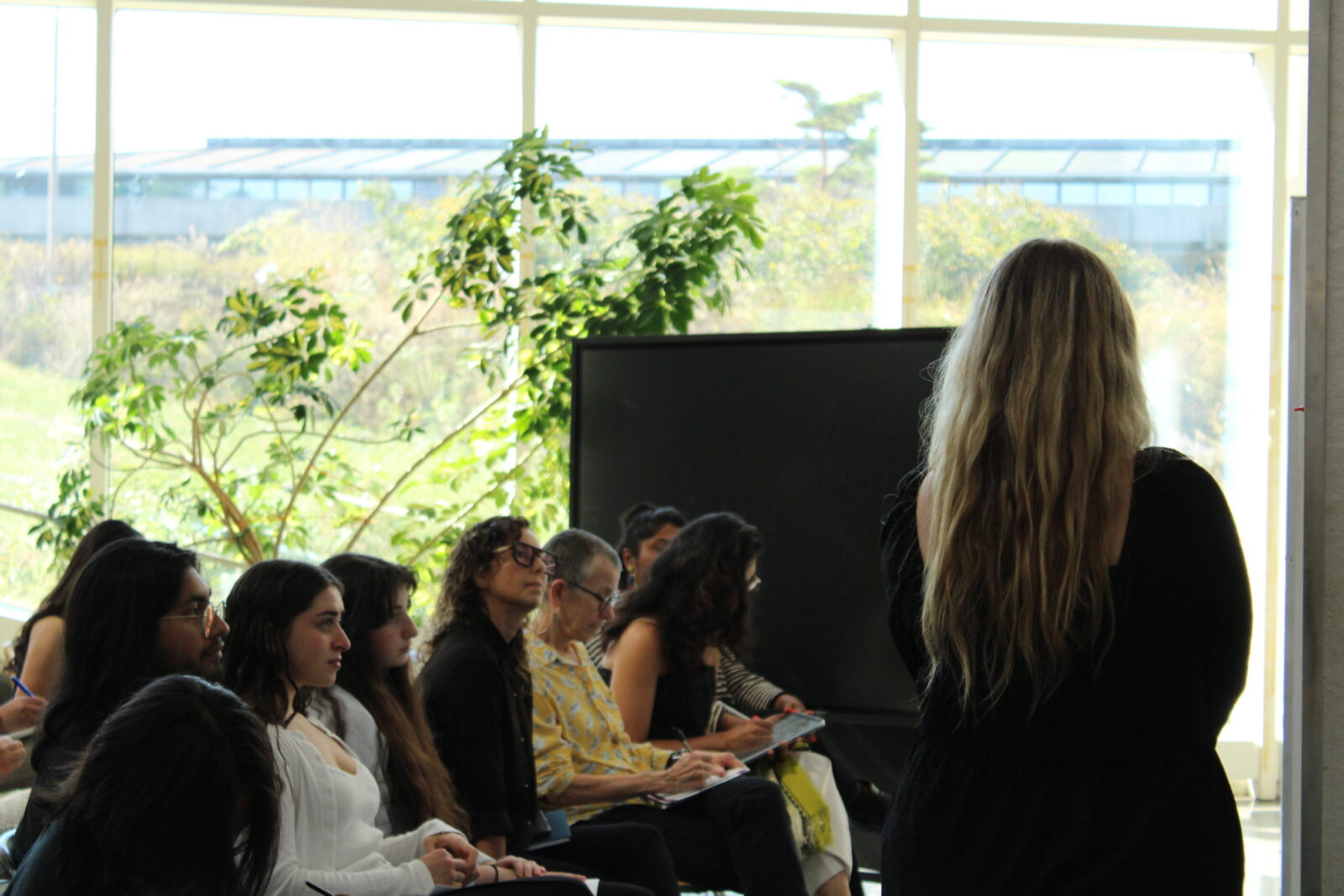 the back of a student standing in front of an audience