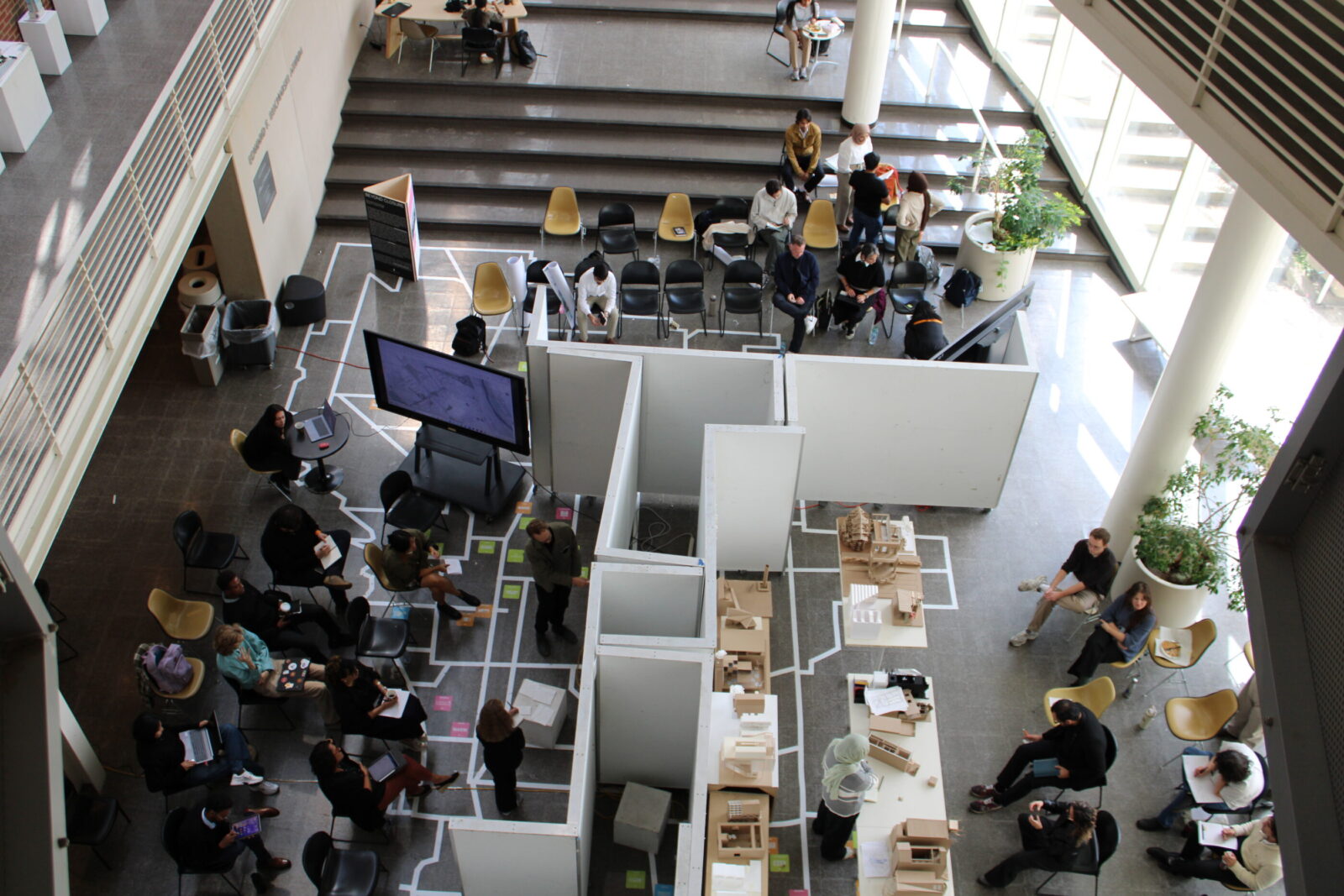 an overhead view of the atrium space with models and people